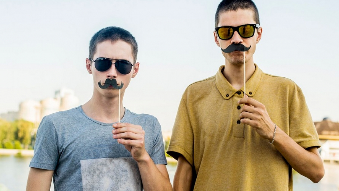Men's mental health: Two young men with pretend mustaches